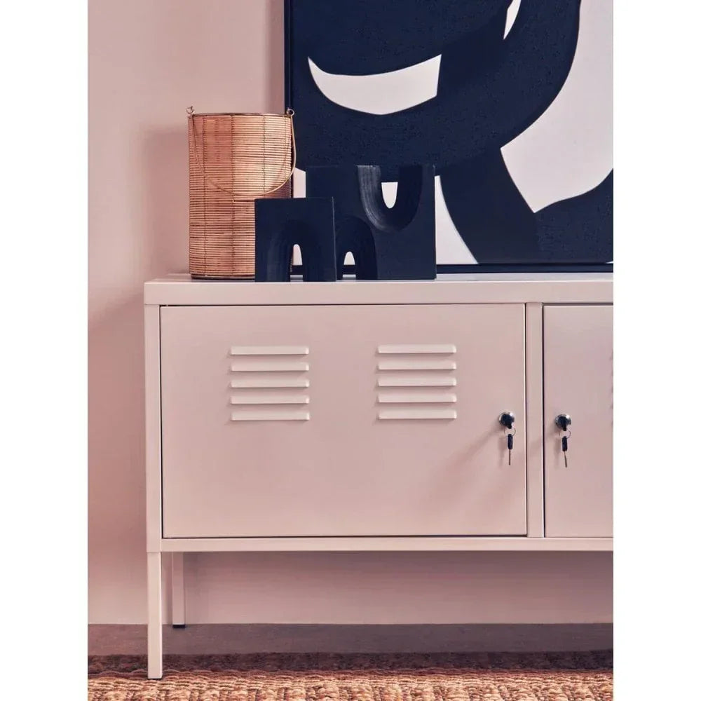 Cream metal storage cabinet with louvered doors, decorative pieces and abstract art