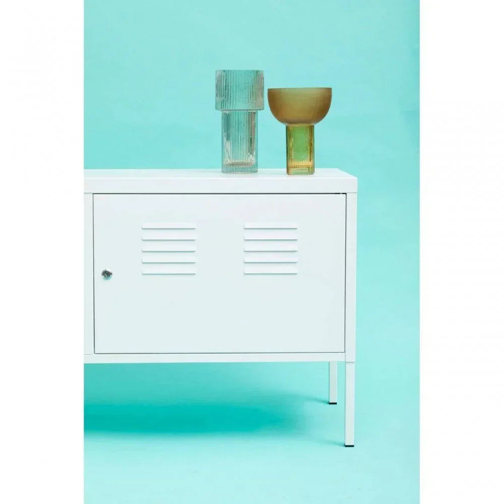 White metal storage cabinet with vented door and two decorative glass vases on top