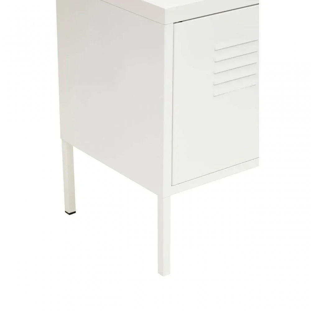 White metal storage cabinet with louvered door and slim legs, photographed from angle