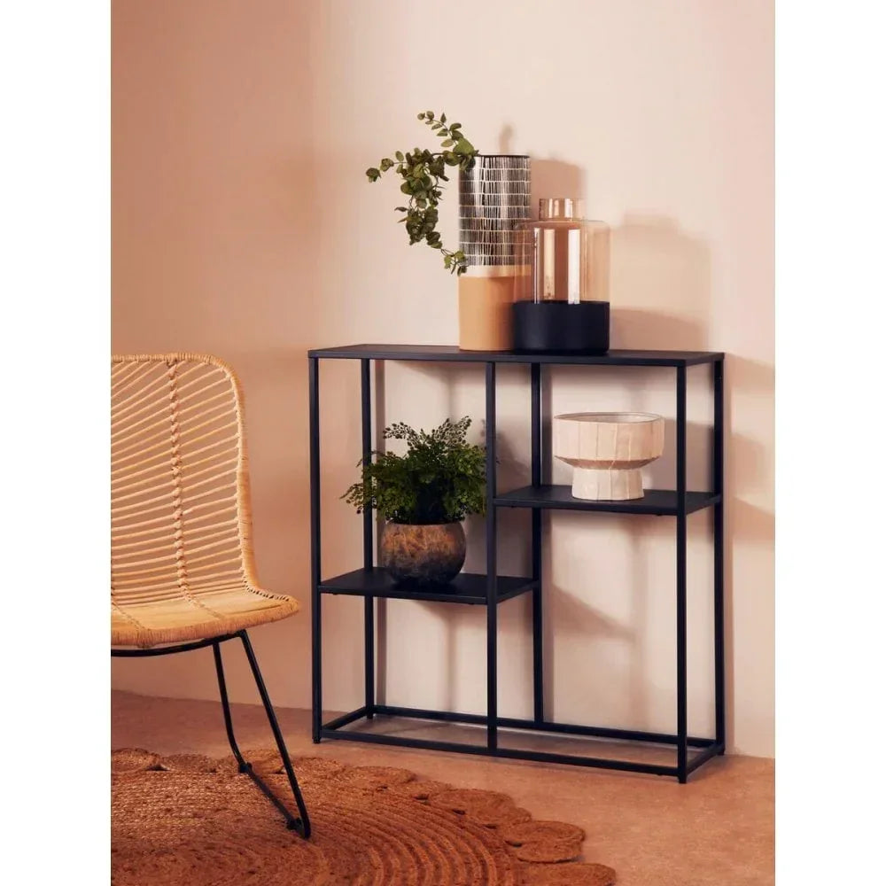 Black metal console table with open shelves, decorative vases, and plant display