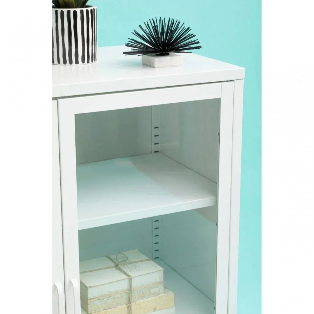 White display cabinet with glass door and adjustable shelf against blue wall