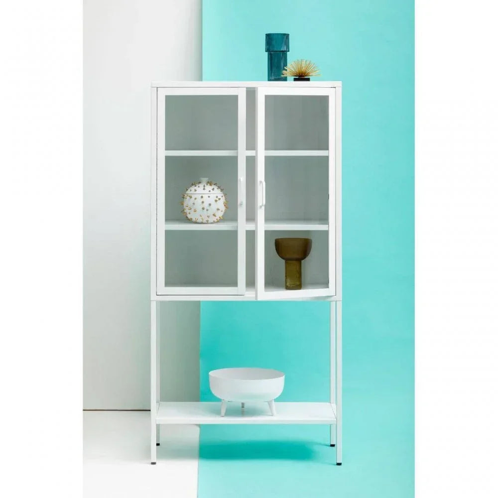 White glass display cabinet with shelving, decorative items, and metal frame against blue wall