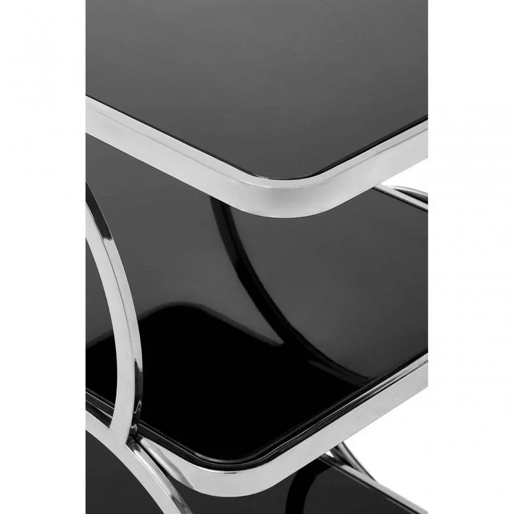 Close-up of black glass shelving unit with chrome frame and rounded edges