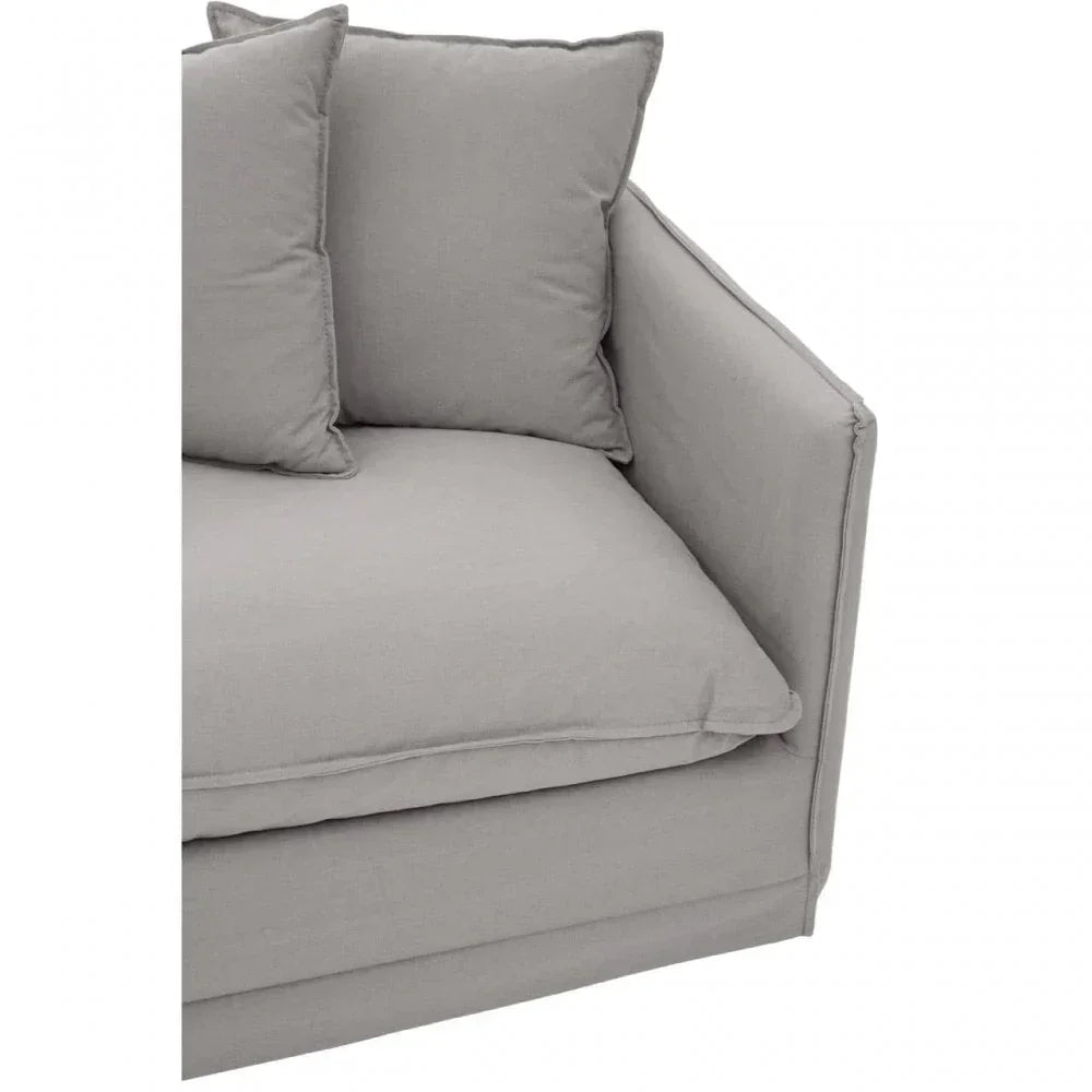 Light grey fabric sofa corner with two matching scatter cushions, close-up view