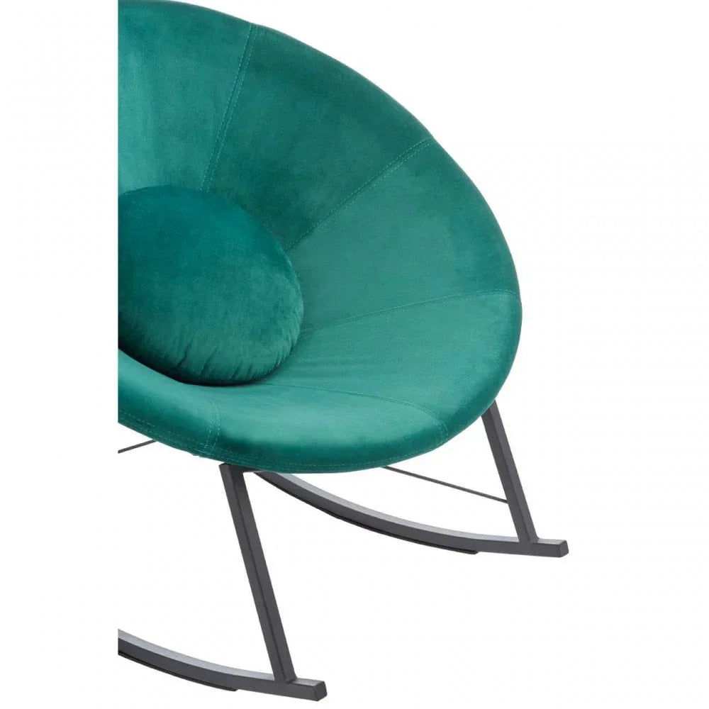 Green velvet accent chair with round cushion and metal rocking frame, close-up view