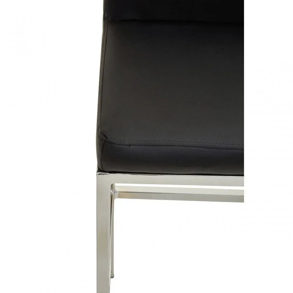 Close-up of dining chair with black seat cushion and chrome metal frame