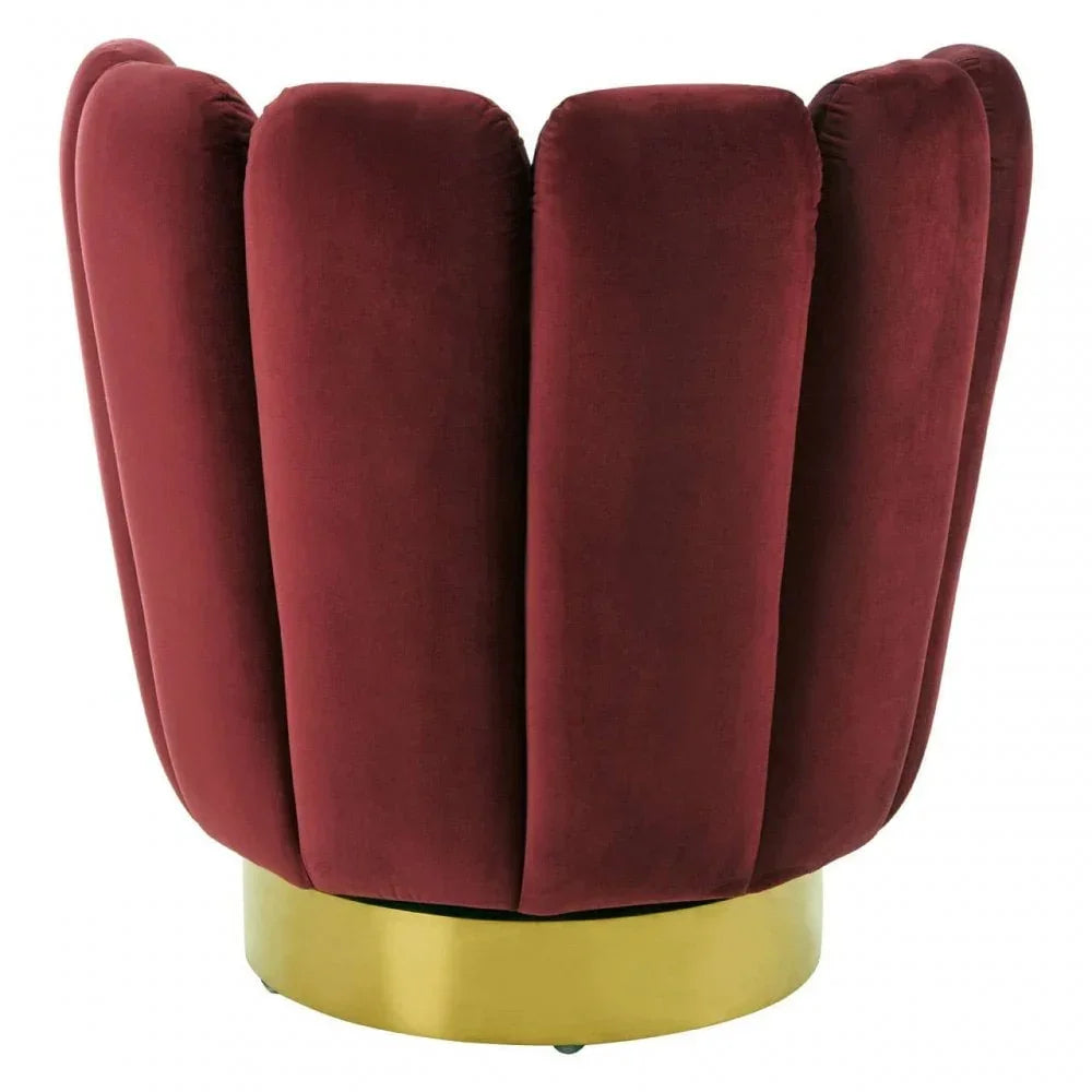 Red velvet accent chair with vertical panels and gold metal base, side angle view