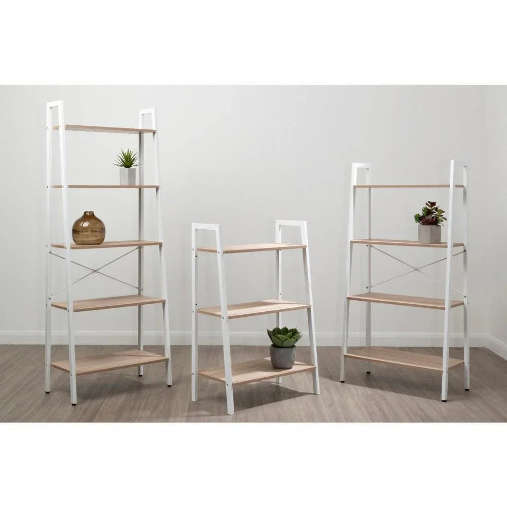 Set of three white metal and light wood shelving units with decorative plants and vase