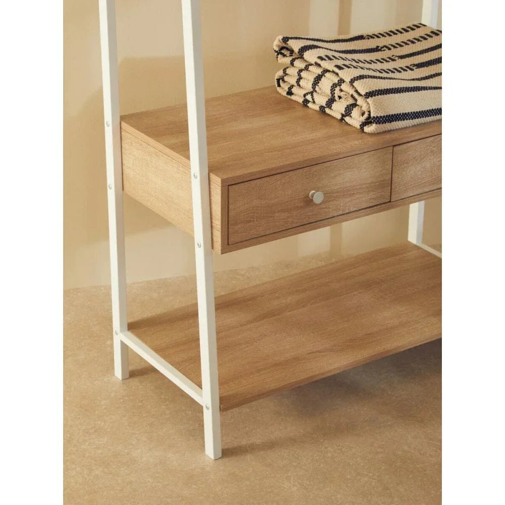 Wood and metal shelving unit with lower storage shelf and folded striped blanket on top