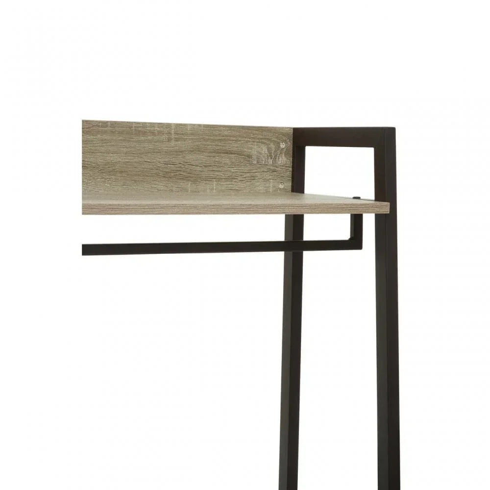 Modern desk corner with oak-effect top and black metal frame, shelf detail visible
