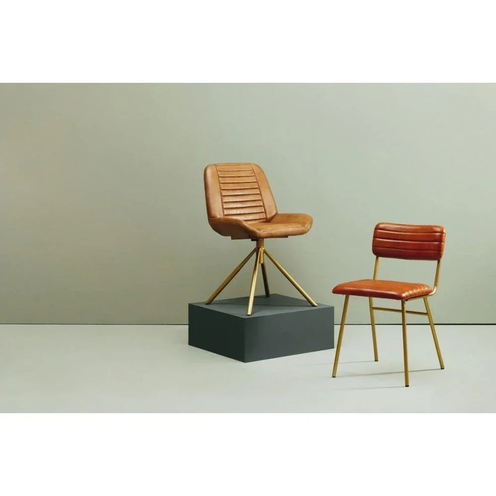 Set of two leather dining chairs with gold metal legs, one swivel chair on display plinth