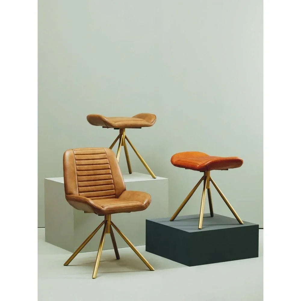 Tan leather dining chair and two matching stools with gold metal legs on display blocks