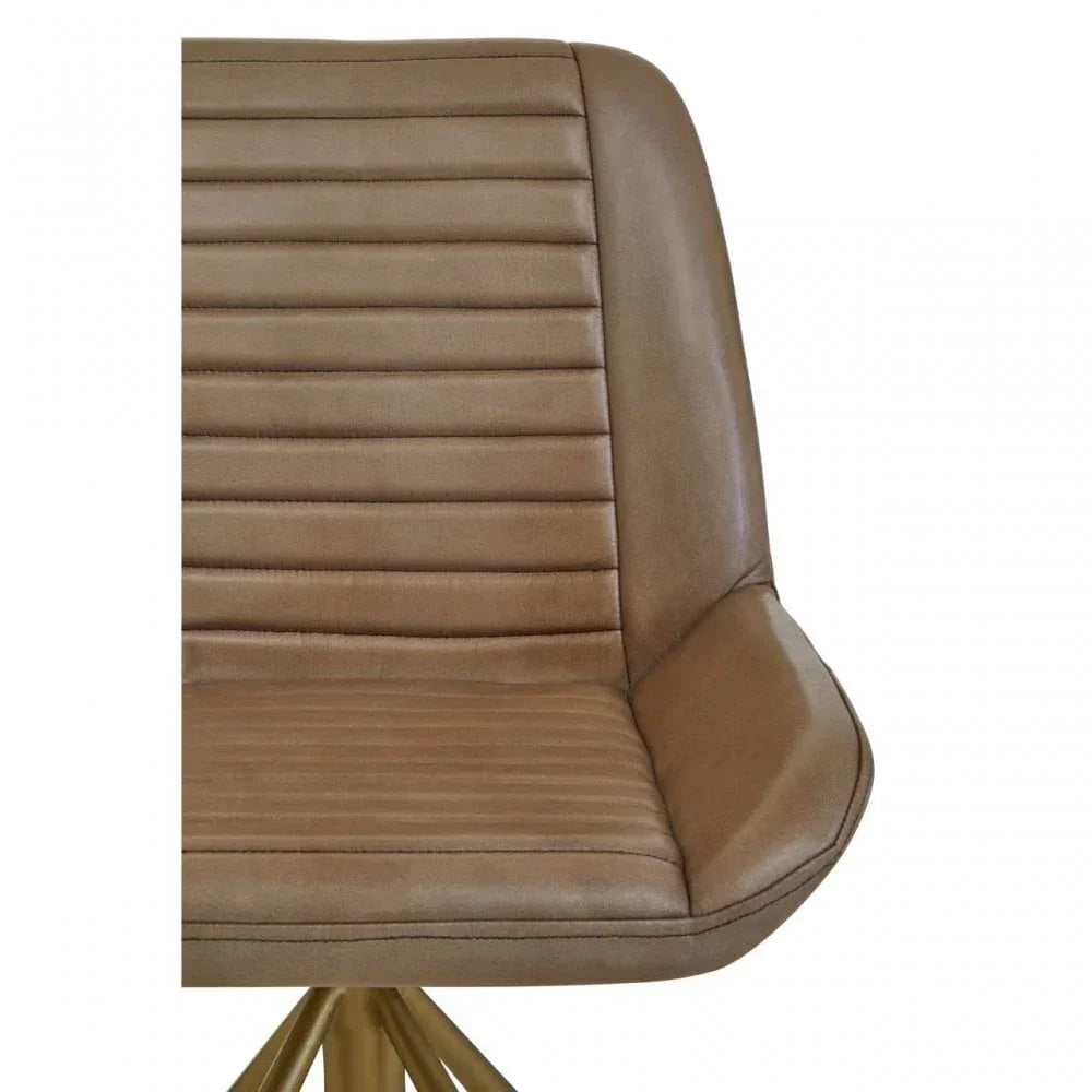 Tan faux leather dining chair with horizontal stitching and gold metal base, close view