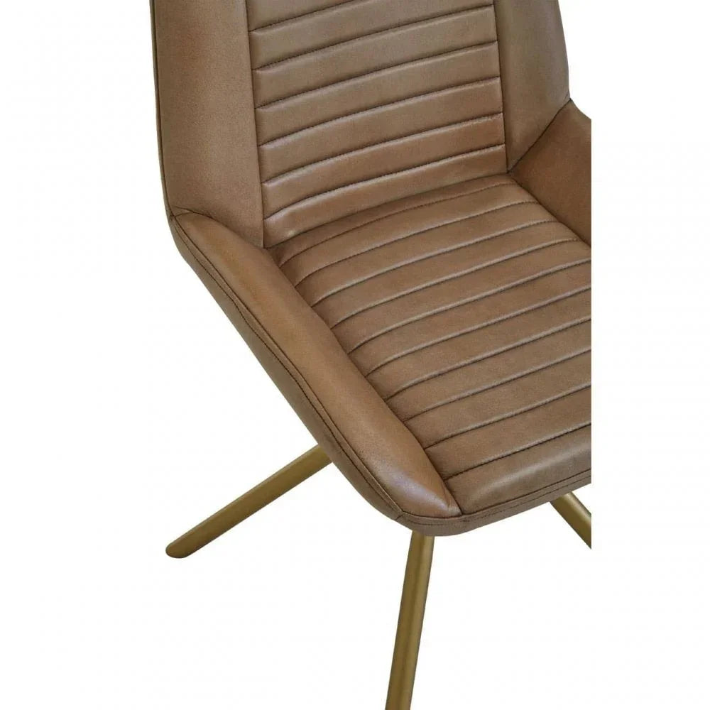 Closeup of brown faux leather dining chair with stitched lines and gold metal legs