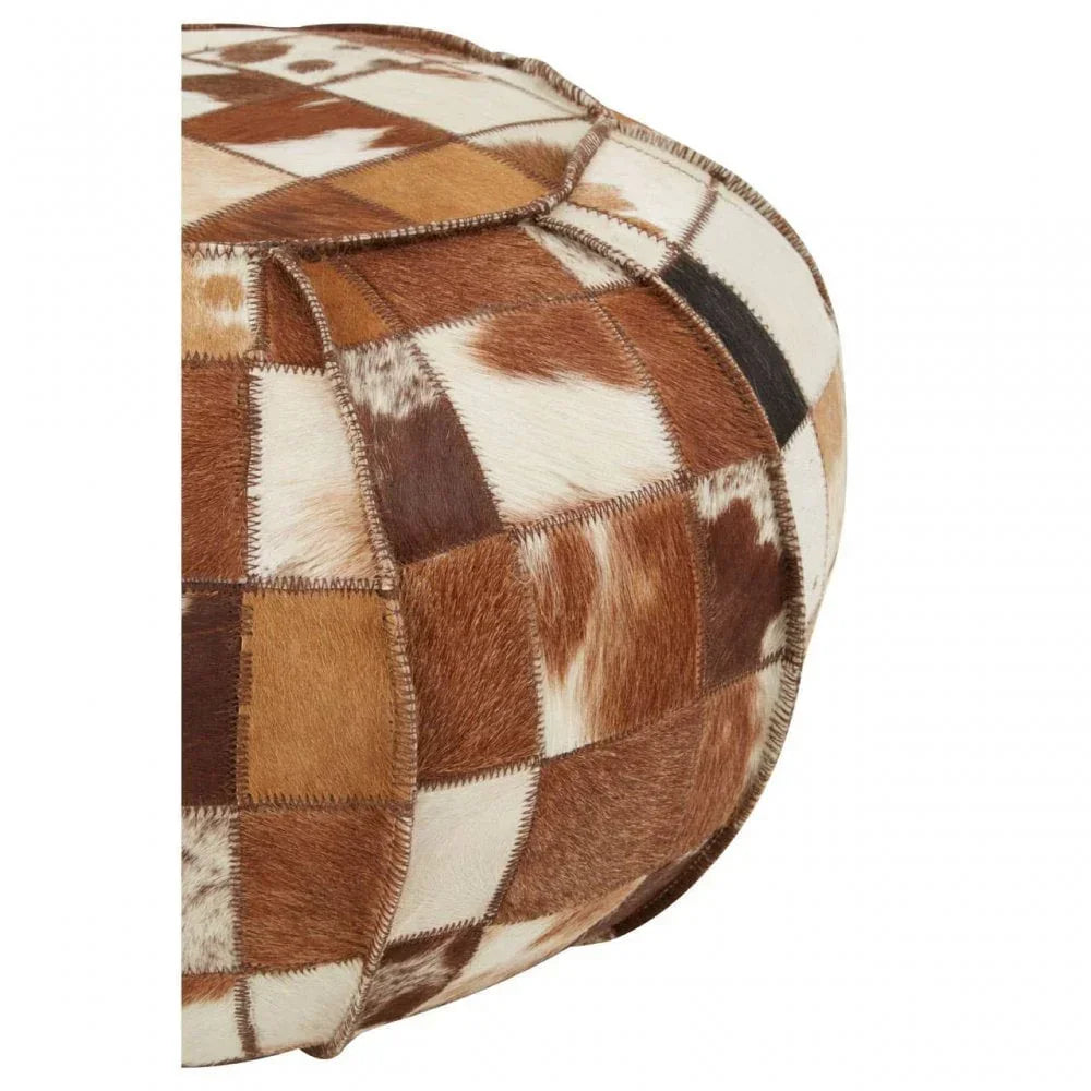 Brown and white patchwork cowhide pouffe close-up showing stitched square panels