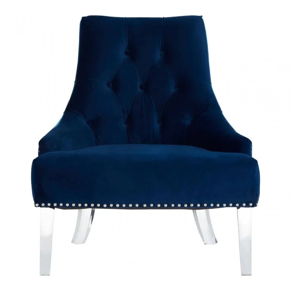 Navy blue velvet accent chair with button-tufted back and clear acrylic legs