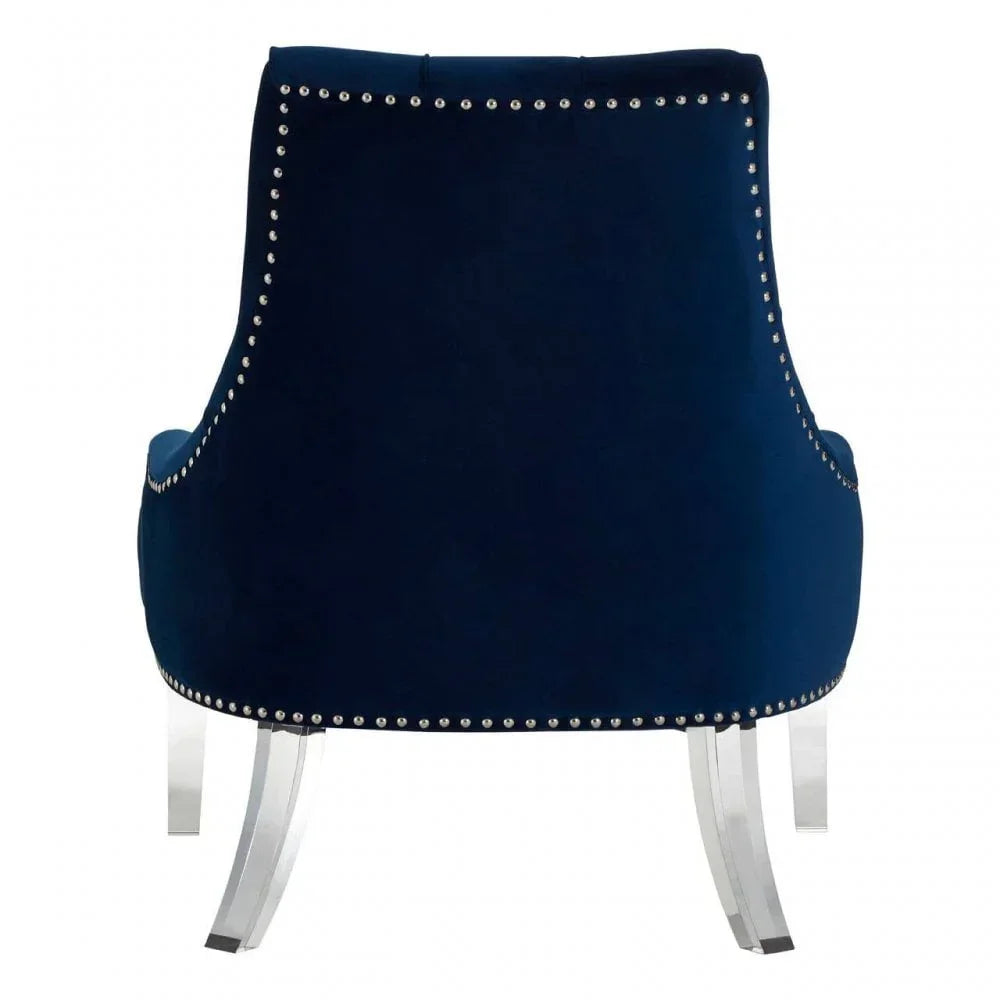 Navy velvet accent chair with chrome stud trim and clear acrylic legs, rear angle view