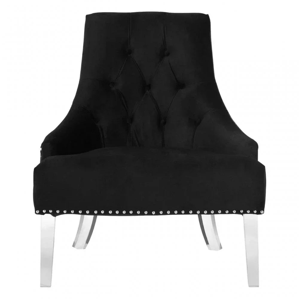 Black velvet accent chair with tufted backrest and silver metal legs front view