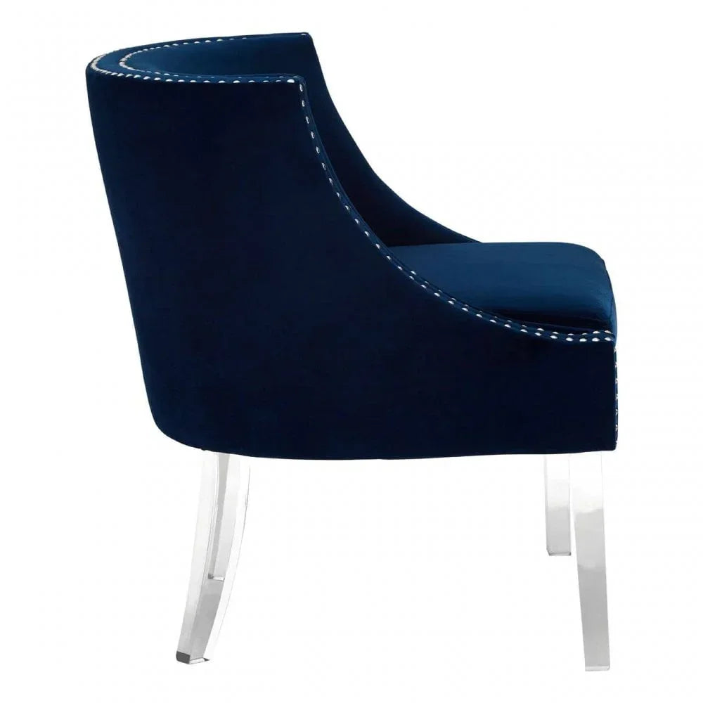 Navy blue velvet accent chair with white stitching and clear acrylic legs, side view