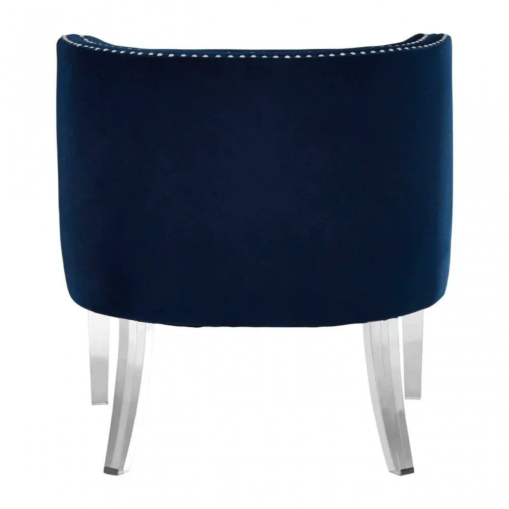 Navy velvet accent chair with curved back and clear acrylic legs, rear view