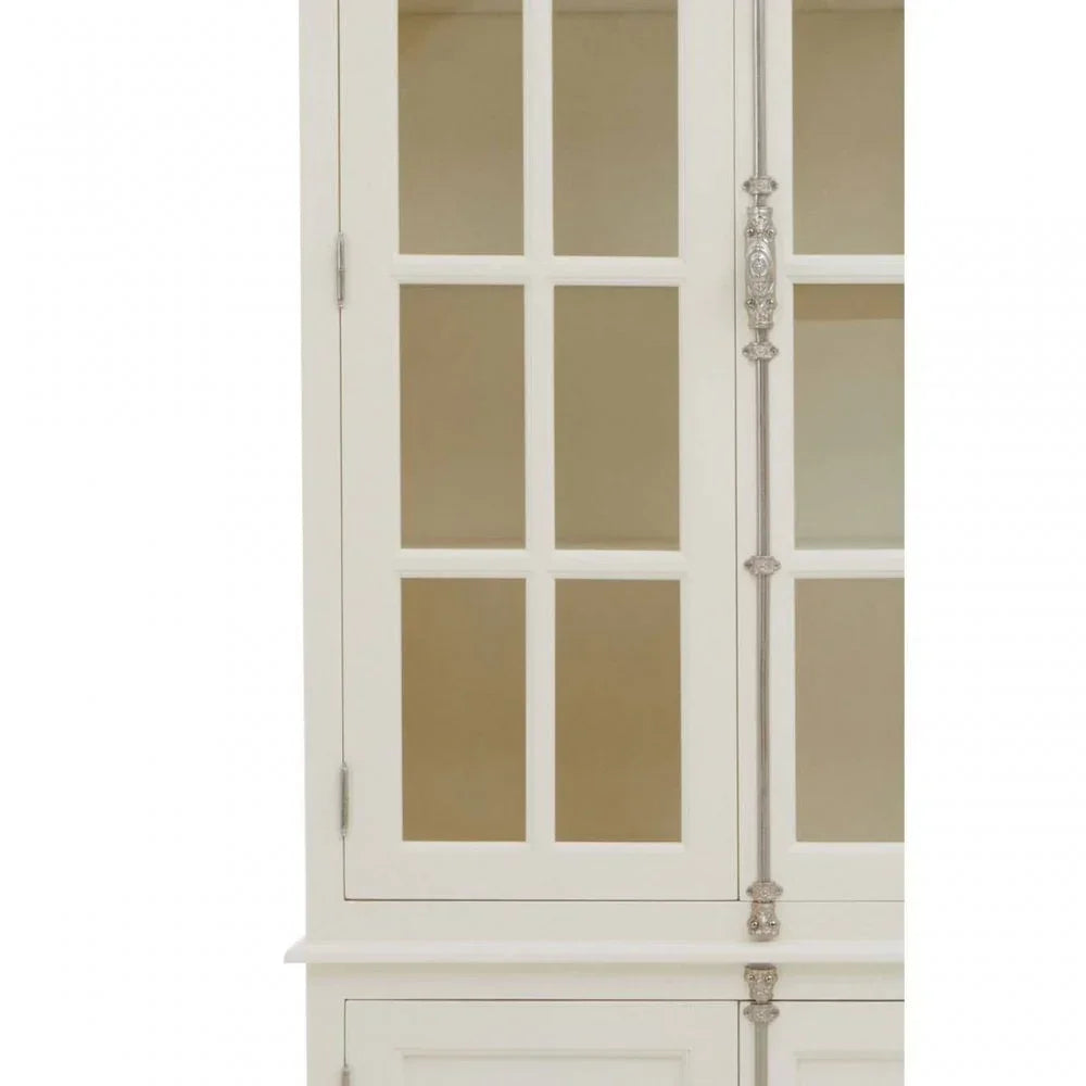 White display cabinet with glass panel doors and silver ornate handles, close-up view