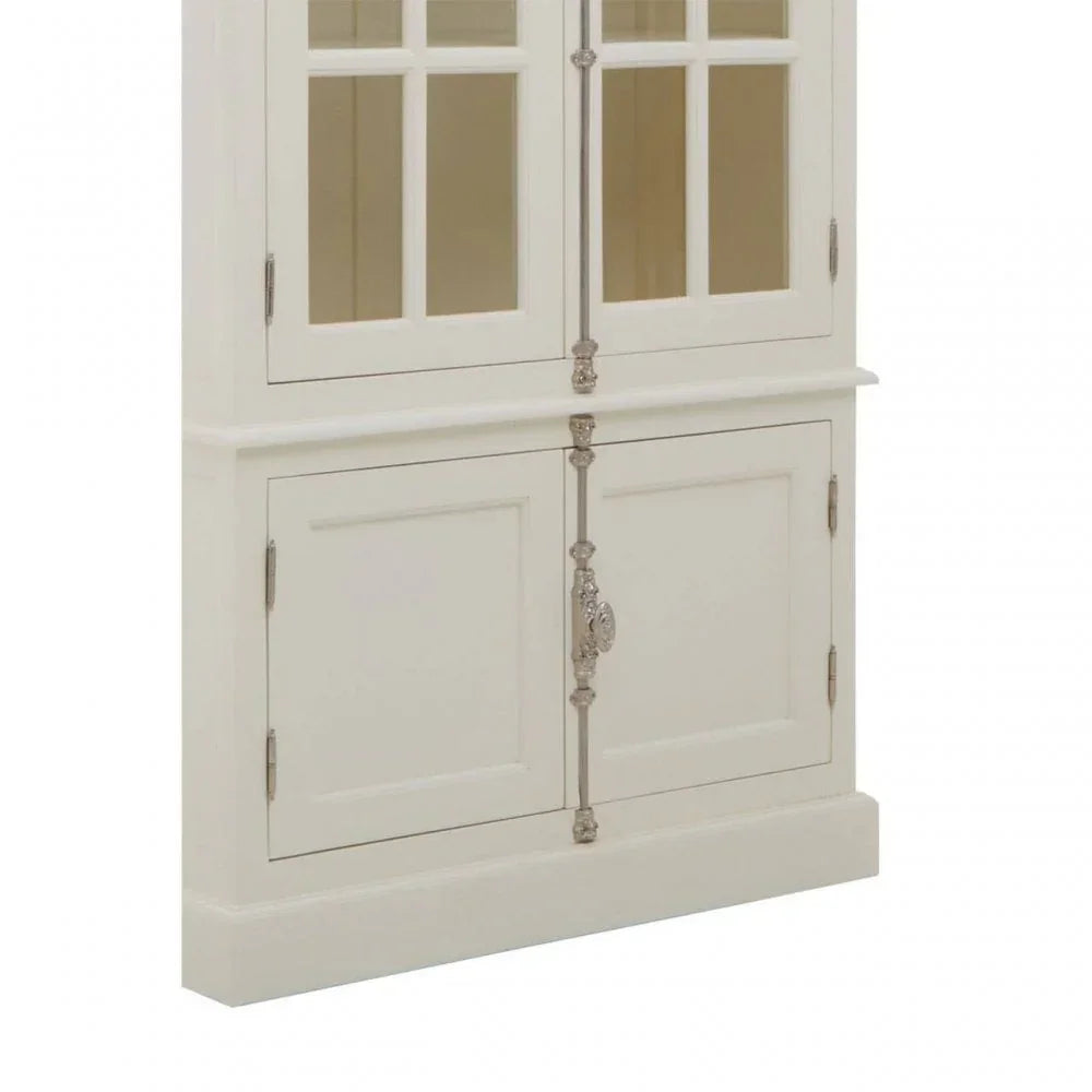White wooden cabinet with glass upper doors and ornate silver handles