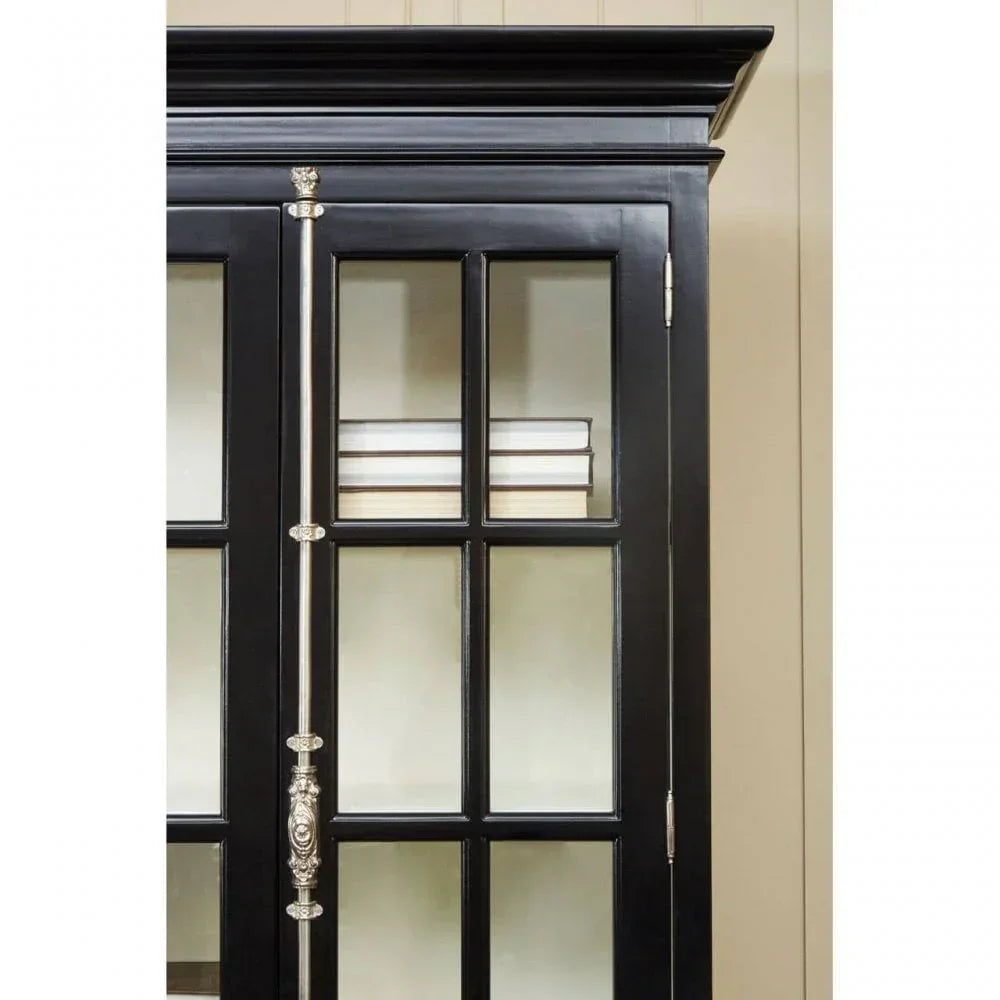 Black glass display cabinet with decorative hinge and books on upper shelf