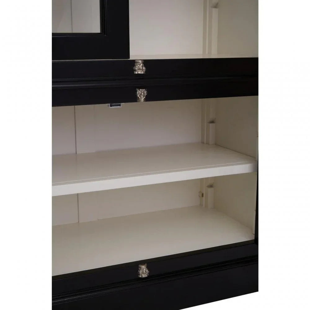 Black and white cabinet interior with two shelves and decorative silver drawer handles