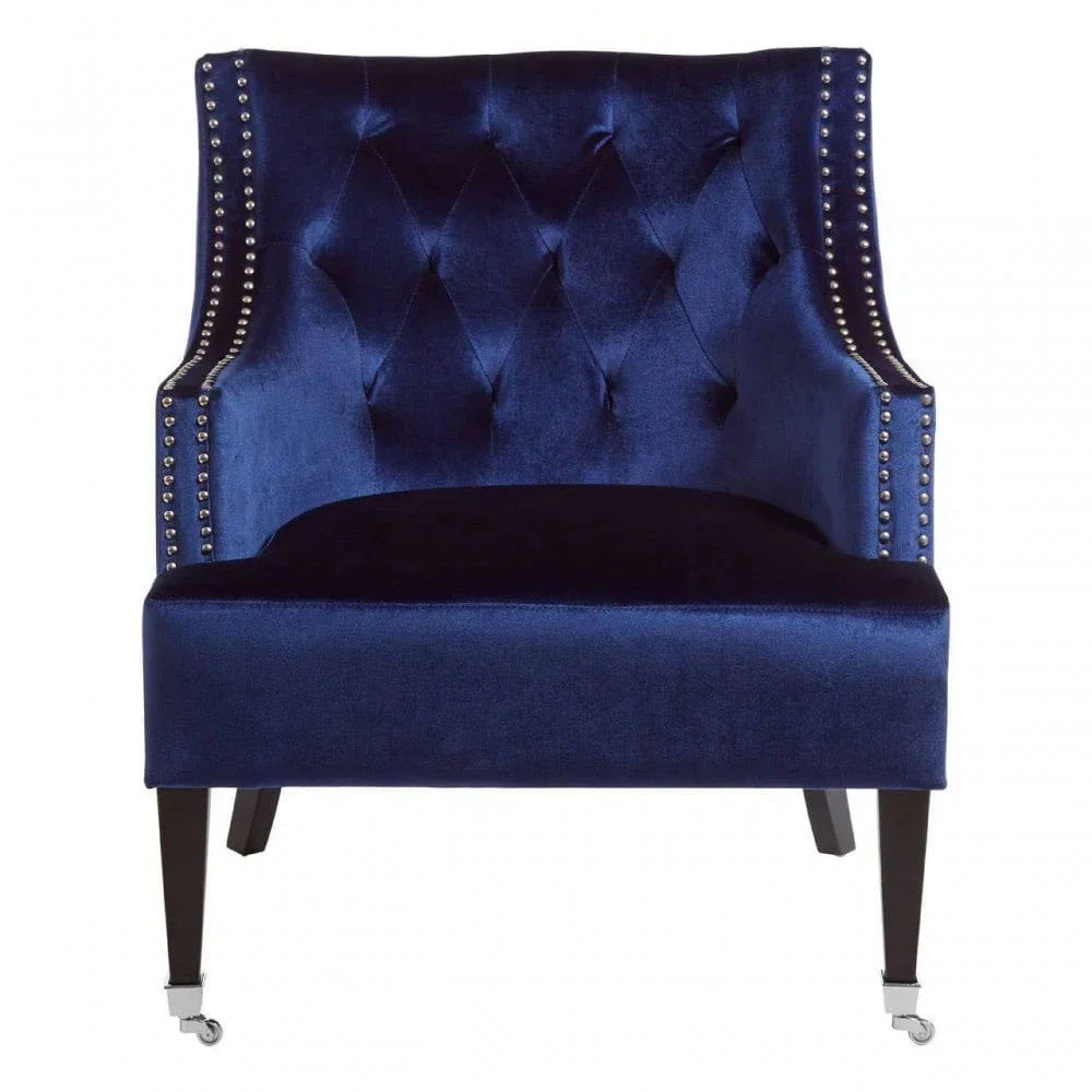 Navy blue velvet accent chair with studded trim and dark wooden legs, front view