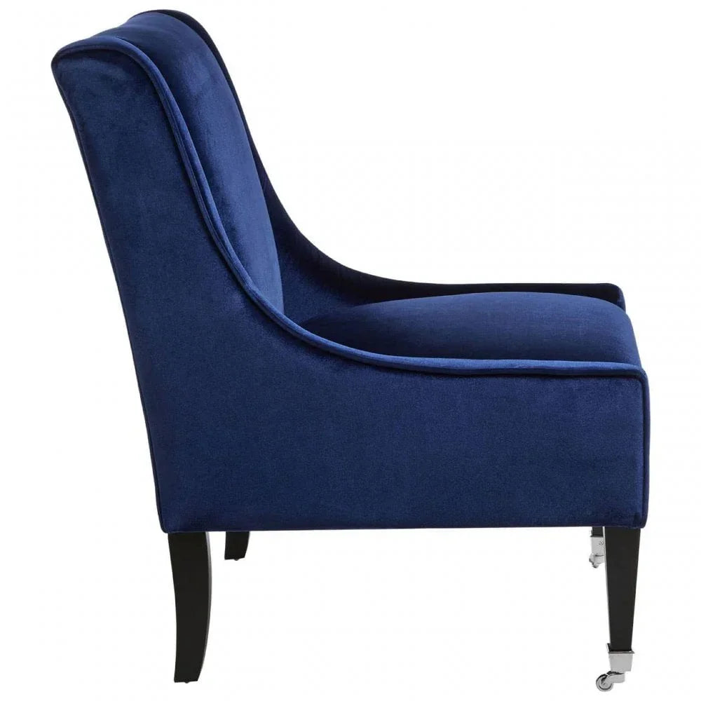 Side view of blue velvet accent chair with black wooden legs and caster wheels