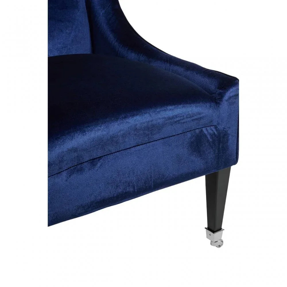 Blue velvet armchair seat with black leg and chrome castor wheel