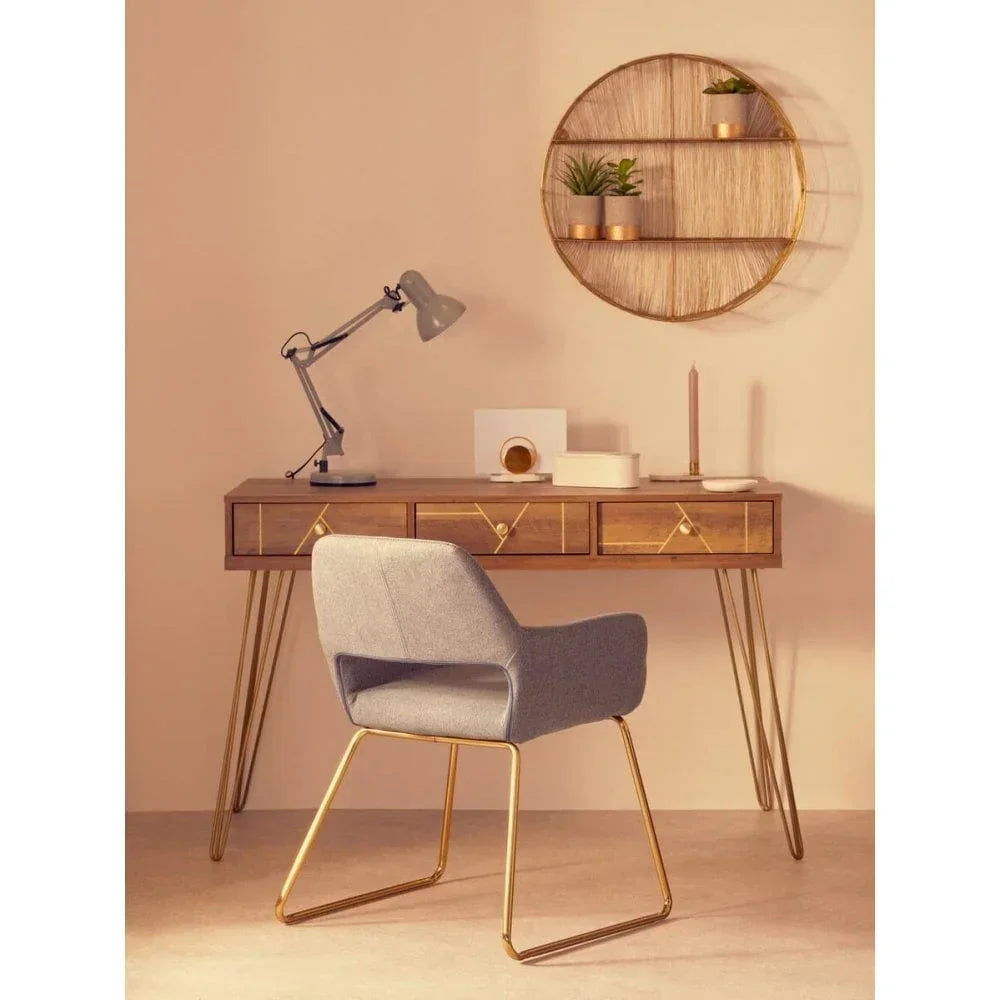Modern desk with wooden drawers, grey office chair, and gold metal legs in home office