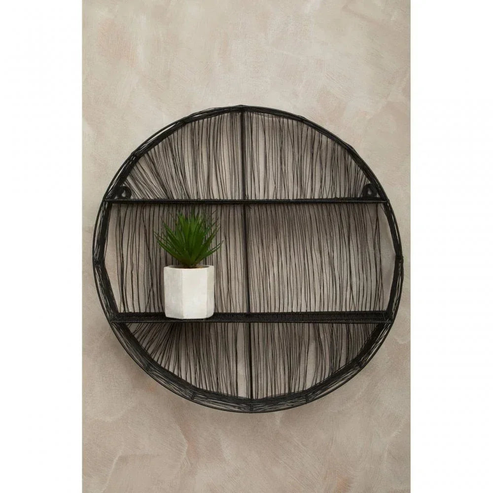 Black metal round wall shelf with geometric wire design and small potted plant