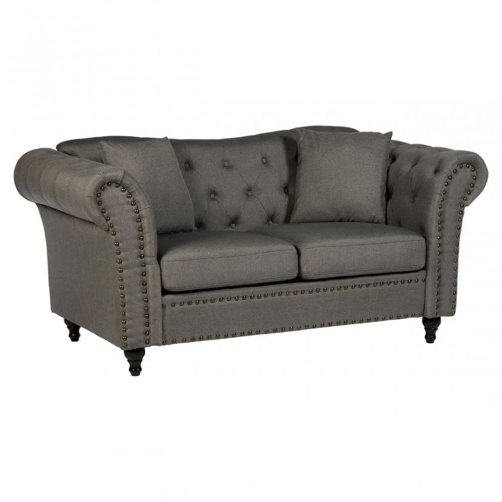 Grey fabric chesterfield sofa with button-tufted back, studded trim and matching cushions