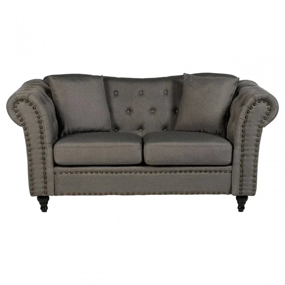 Grey fabric sofa with button-tufted back, studded trim, and rolled arms, front view