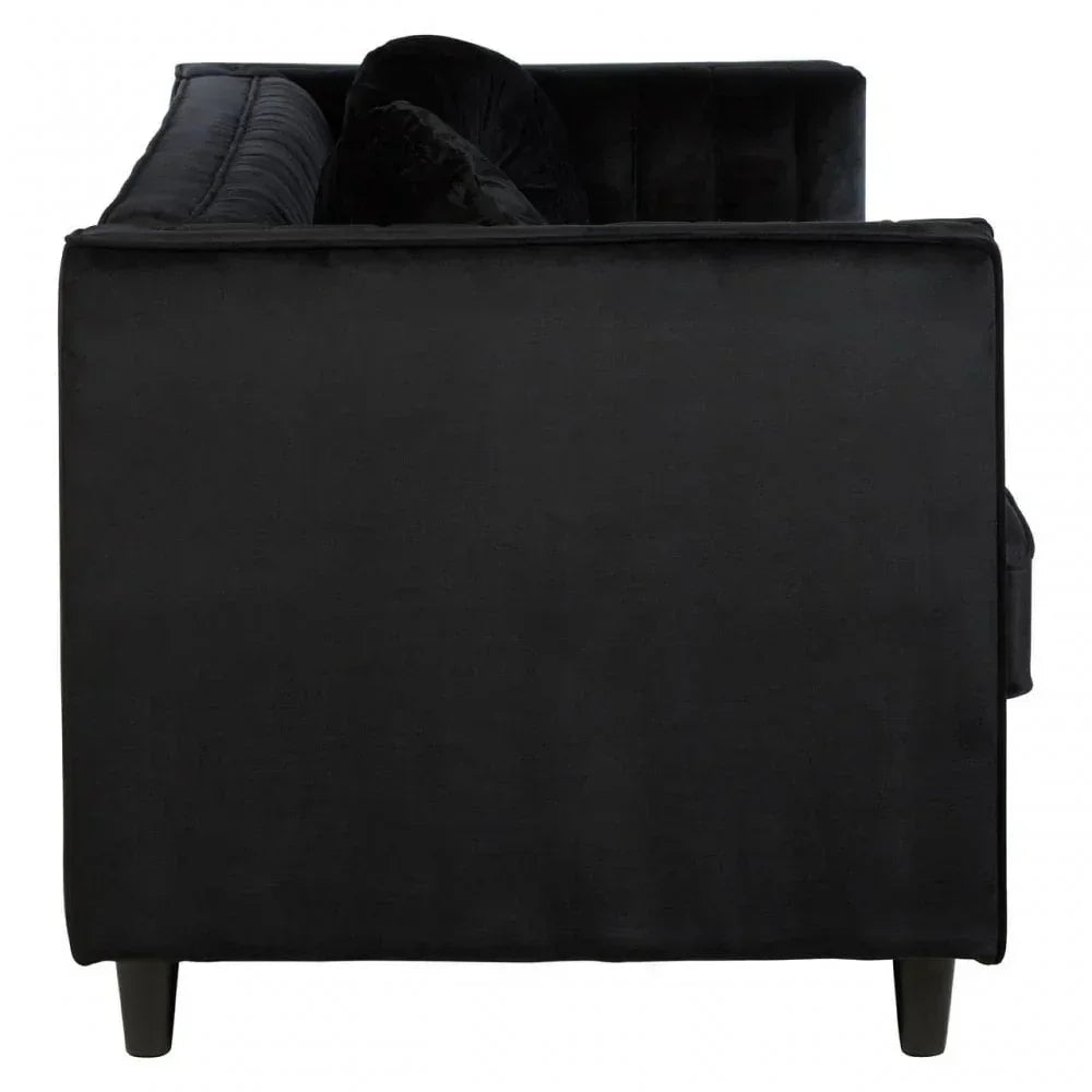 Side view of black velvet sofa with tufted backrest and wooden legs