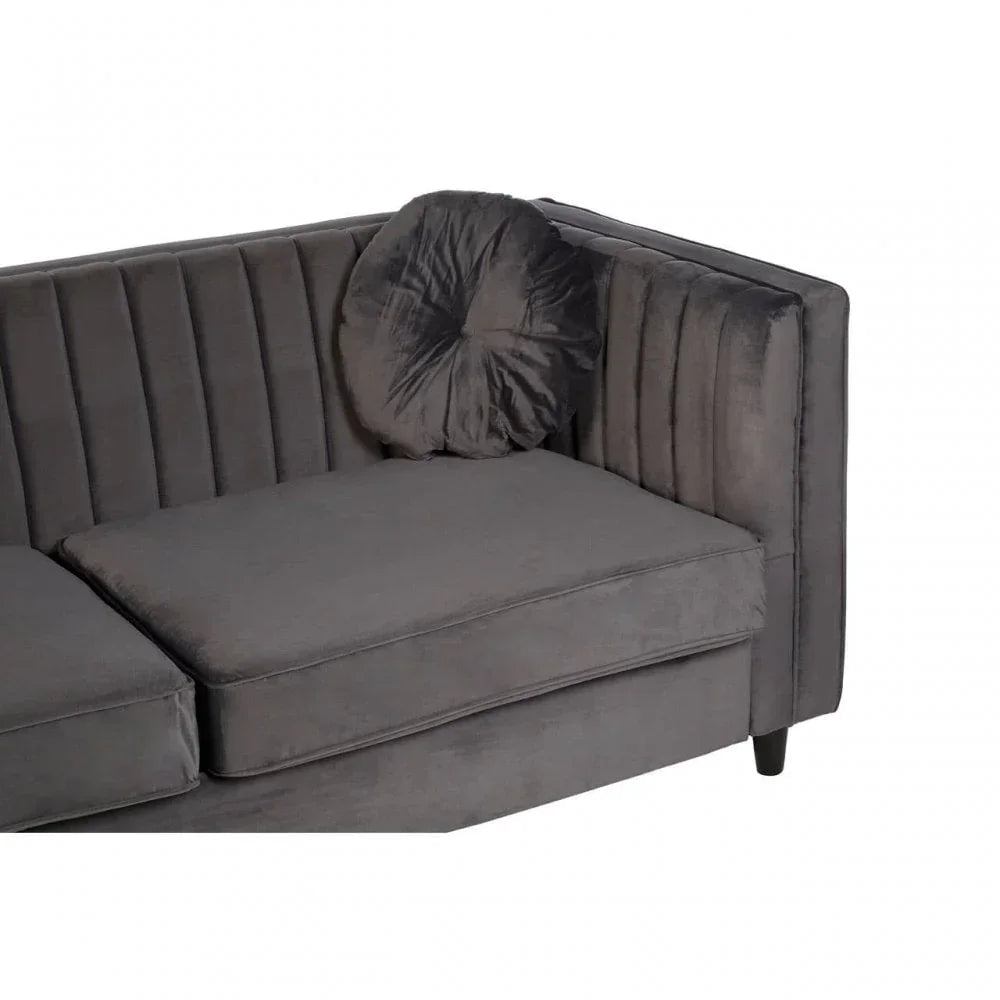 Dark grey velvet corner sofa with channel tufted backrest and round cushion