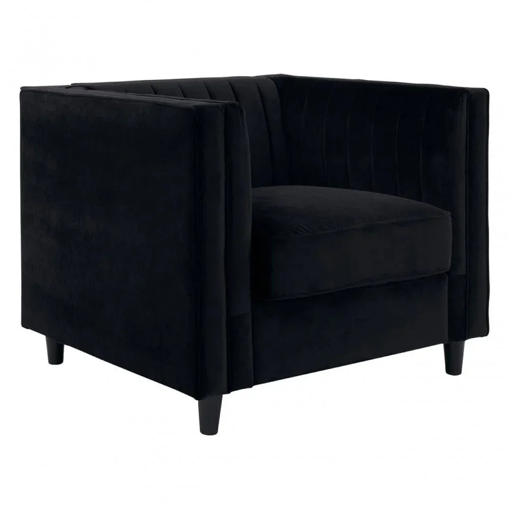 Black velvet armchair with deep seat and vertical stitching on backrest, angled front view