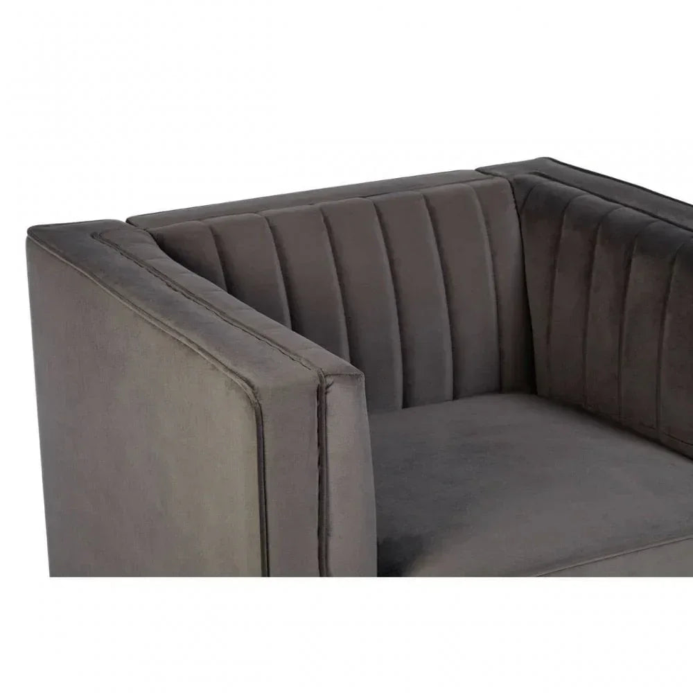 Close-up of grey velvet armchair with vertical stitched back and armrest detail