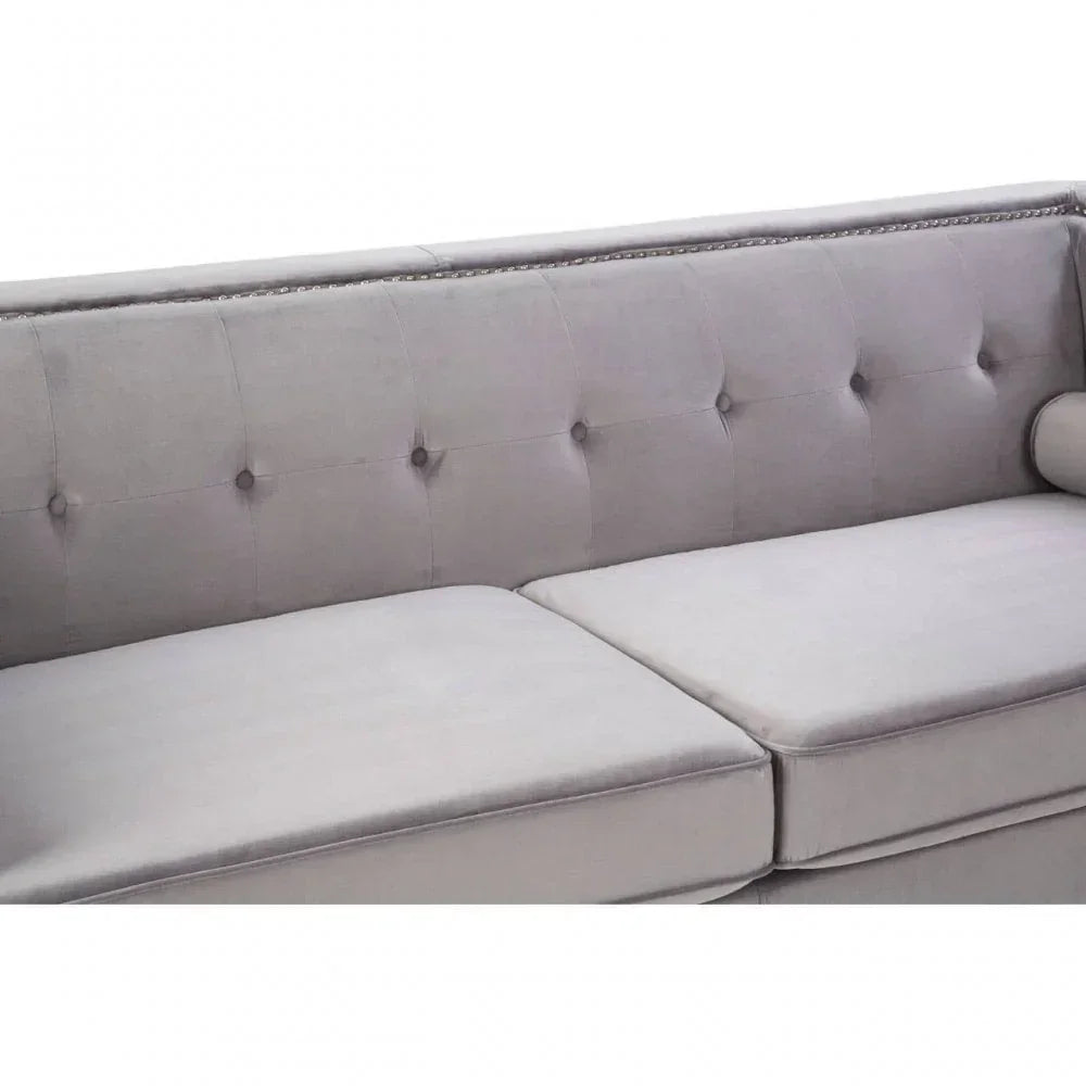 Light grey fabric sofa with button-tufted backrest, silver stud detailing and seat cushions