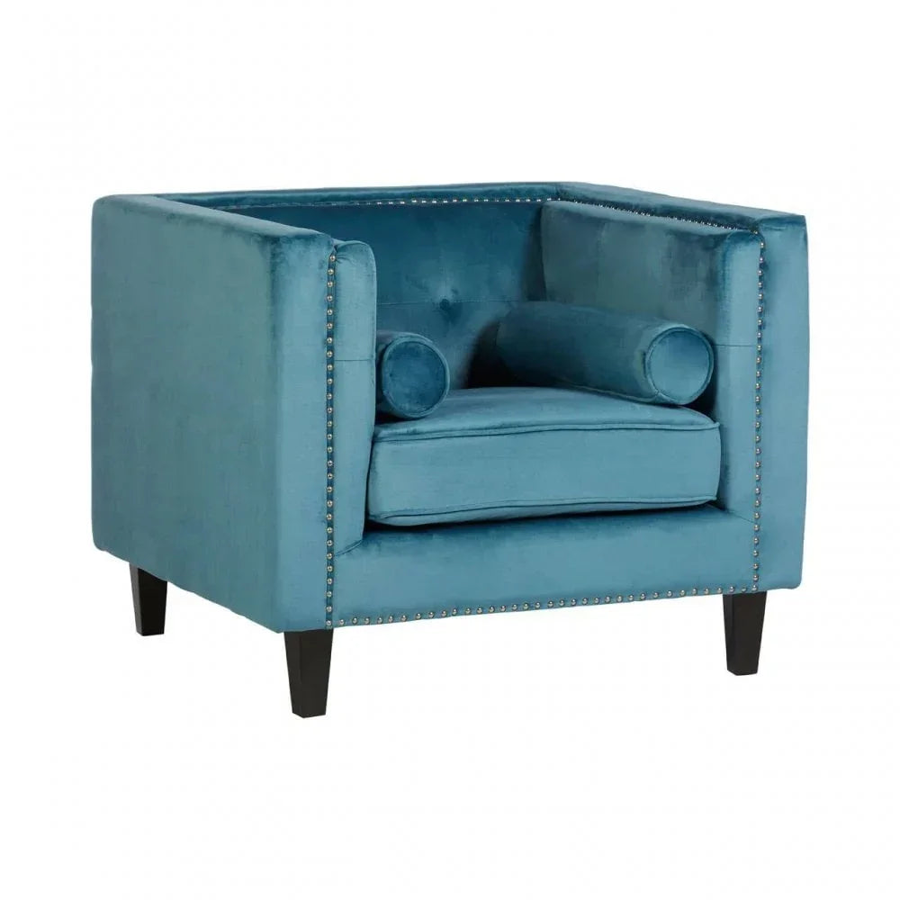 Blue velvet armchair with studded trim, square shape, and two matching bolster cushions