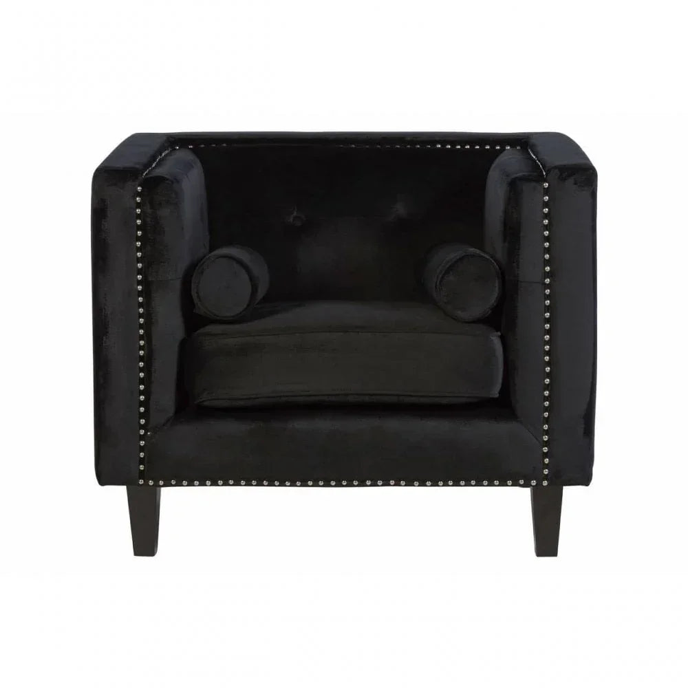 Black velvet armchair with nailhead trim and cylindrical cushions, front view