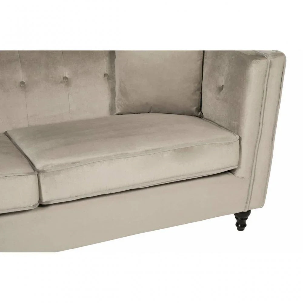 Light grey velvet sofa corner with tufted backrest and turned wooden leg