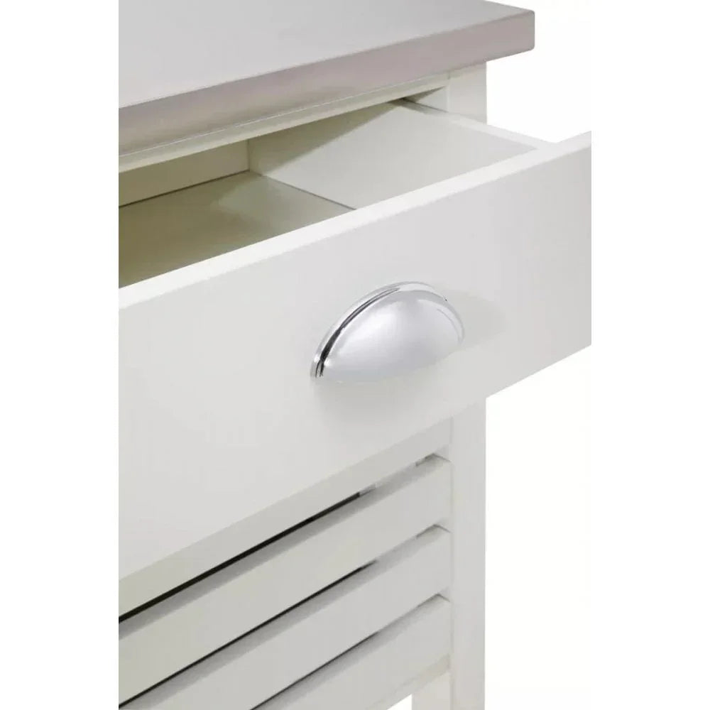 White wooden drawer unit with silver handle and slatted panel, close-up view