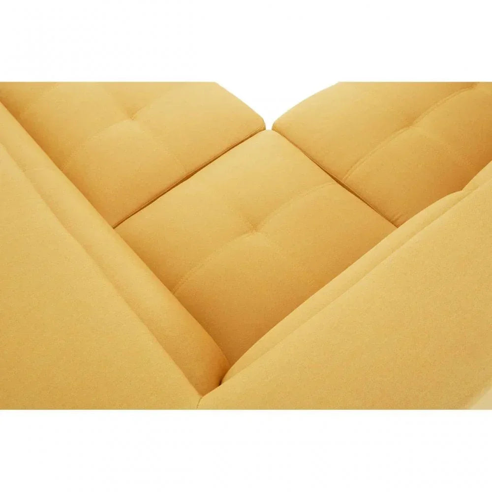Corner detail of yellow fabric sofa with tufted seat cushions