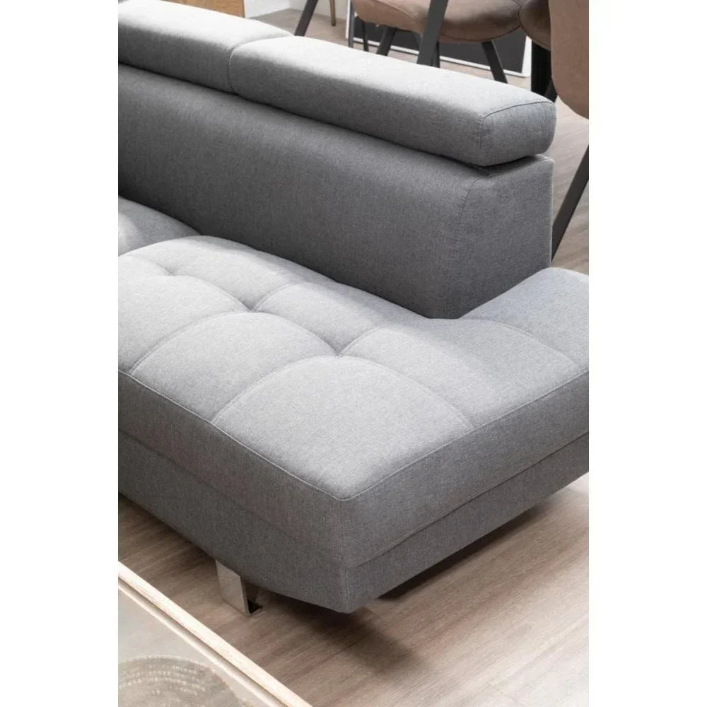 Grey fabric sofa with adjustable headrest and tufted seat in modern living room
