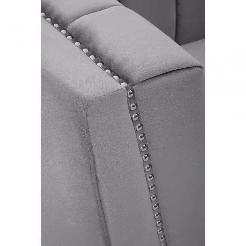 Grey velvet sofa arm with silver stud detailing and piped edges