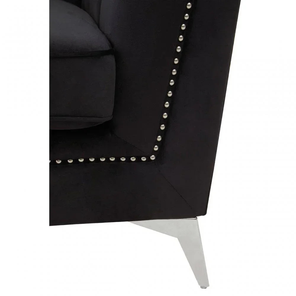 Black velvet sofa corner with silver stud detailing and chrome metal leg