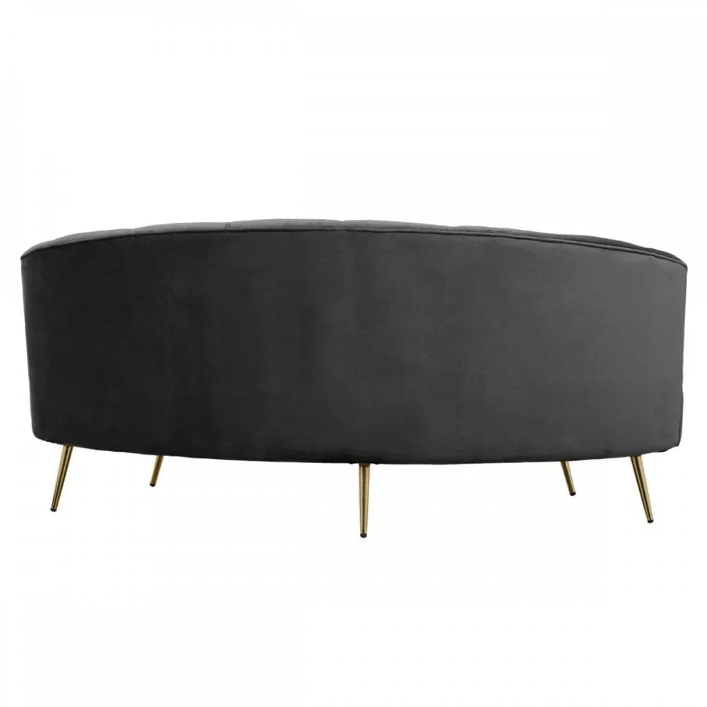 Back view of a black velvet sofa with gold metal legs on white background