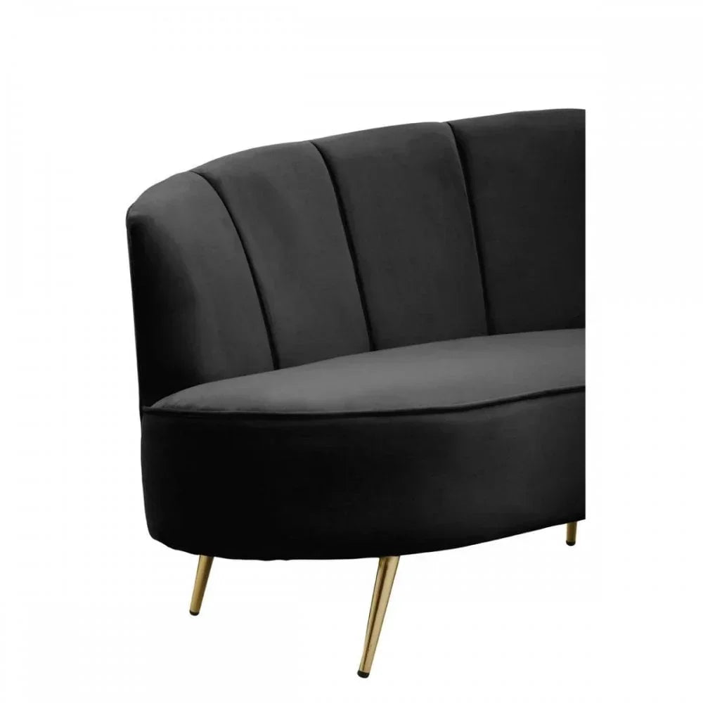 Black velvet sofa with channel tufted back and gold metal legs side view